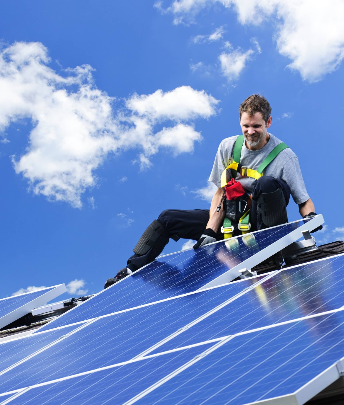 Solar panel installation with technician using tools
